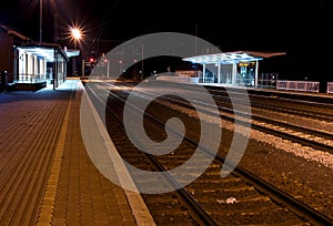 Outside a train station, at night