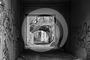 On the outskirts of the city, graffiti in the arch, black and white photo