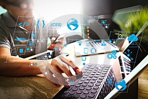 Outsource Developer working on marble Desk Working Laptop Computer Mobile Application Software and digital tablet dock smart