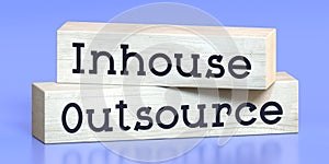 Outsource, inhouse - words on wooden blocks
