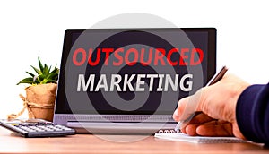 Outsourced marketing symbol. Concept words Outsourced marketing on beautiful black tablet. Beautiful white background. Calculator