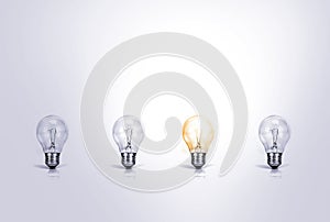 Outstanding creative idea background concept . one Light bulb glowing among a group light bulbs.