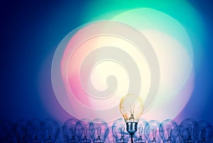 Outstanding creative idea background concept . one Light bulb glowing among a group light bulbs.