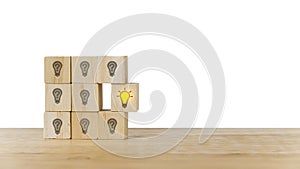 Outstanding wooden cube block with bright light bulb icon