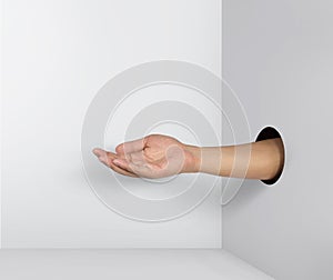 Outstretched hand gesture, holding, asking or offering something, coming out from a hole of paper