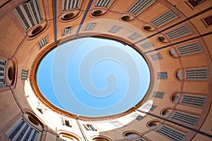 Oval blue sky in Italian urban court