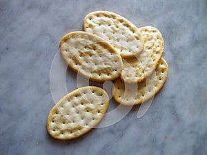 oval bread crackers, food industrial product, on marble background