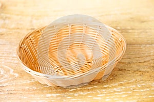 Oval shaped wicker basket on a wooden table