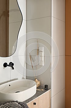 Oval washbasin in simple bathroom