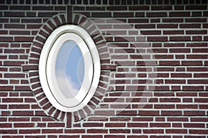 Oval window in brick wall