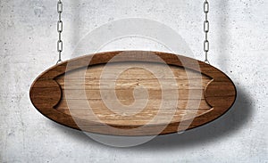 Oval wooden sign hanging on chains with concrete wall background