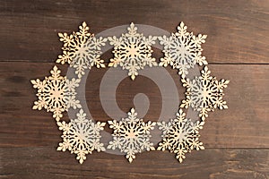 Oval snowflake frame design on wooden table