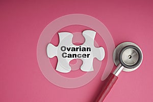 OVARIAN CANCER text with Stethoscope on white jigsaw puzzle