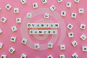 Ovarian cancer word made of square letter word on pink background. photo