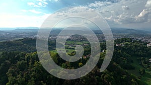 OVARO MIONE, ITALY - APRIL, 2023: Aerial drone view of a valley in the morning with clouds. Small mauntain village Mione