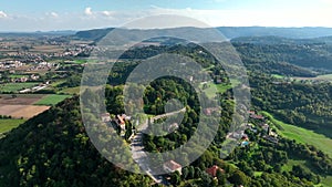 OVARO MIONE, ITALY - APRIL, 2023: Aerial drone view of a valley in the morning with clouds. Small mauntain village Mione