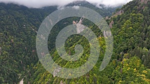 OVARO MIONE, ITALY - APRIL, 2023: Aerial drone view of a valley in the morning with clouds. Small mauntain village Mione