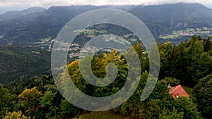 OVARO MIONE, ITALY - APRIL, 2023: Aerial drone view of a valley in the morning with clouds. Small mauntain village Mione