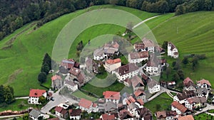 OVARO MIONE, ITALY - APRIL, 2023: Aerial drone view of a valley in the morning with clouds. Small mauntain village Mione