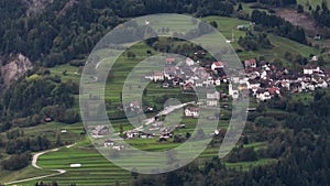 OVARO MIONE, ITALY - APRIL, 2023: Aerial drone view of a valley in the morning with clouds. Small mauntain village Mione