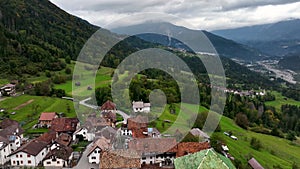 OVARO MIONE, ITALY - APRIL, 2023: Aerial drone view of a valley in the morning with clouds. Small mauntain village Mione