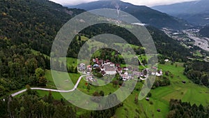 OVARO MIONE, ITALY - APRIL, 2023: Aerial drone view of a valley in the morning with clouds. Small mauntain village Mione