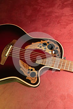 Ovation acoustic guitar in red product shot