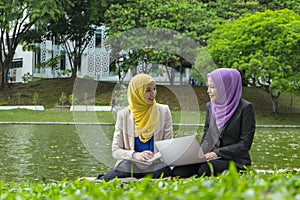 ovely pleasant mix ethnic woman sitting on grass