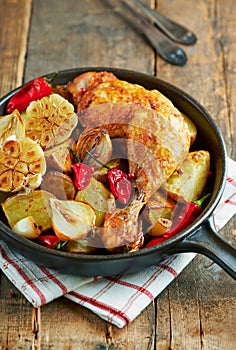 Oven-baked chicken with vegetables and fresh herbs.