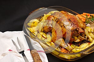 oven-baked crispy crust stuffed chicken on a plate with potatoes and apples