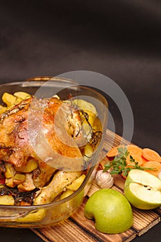 oven-baked crispy crust stuffed chicken on a plate with potatoes and apples