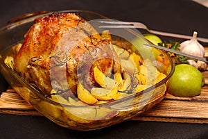 oven-baked crispy crust stuffed chicken on a plate with potatoes and apples