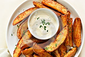 Oven baked potato wedges with sauce