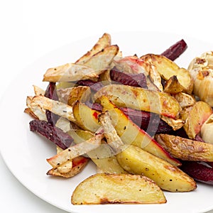 Oven baked potatoes, beetroot, celeriac and garlic photo