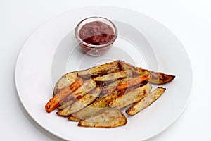 Oven baked potatoes and carrots with ketchup