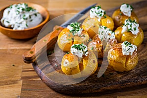 Oven baked potatoes with sour cream with butter and chives