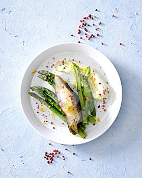 Oven baked sea fish fillet with asparagus and herb butter served with cheese pureed potato