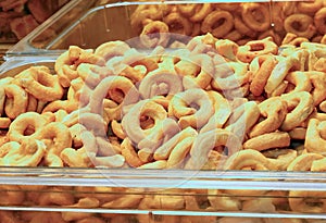 Oven-baked toroidal-shaped breadsticks called Taralli in Italy