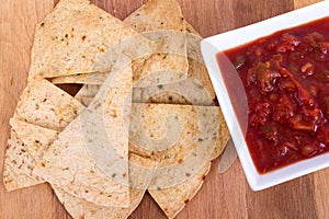 Oven baked tortilla chip with salsa photo