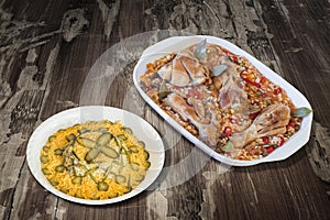 Oven Baked Vegetable Stew with Chicken Meat and Bowl of Garnished Russian Salad set on Old Weathered Wooden Garden Table