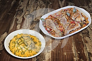 Oven Baked Vegetable Stew with Chicken Meat and Bowl of Garnished Russian Salad set on Old Weathered Wooden Garden Table