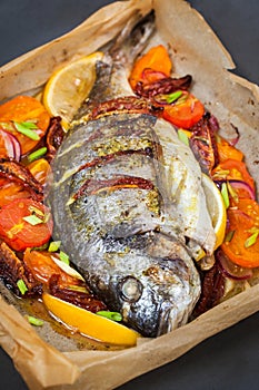 Oven baked whole sea bream fish with vegetables