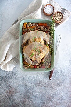 Oven bakes chicken with veggies and mushrooms