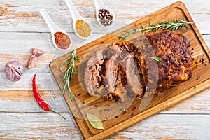 Oven-Barbecued Pork shoulder cut on slices on chopping board