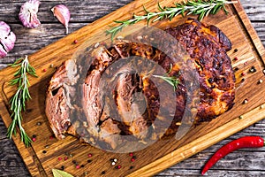Oven-Barbecued Pork shoulder, cut on slices on chopping board