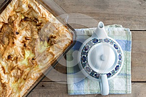Oven dish with plain Turkish borek and a teapot photo