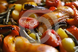 oven grilled chicken legs with delicious curry sauce served on baking tray, baked potatoes with meat, red paprika, green capsicum