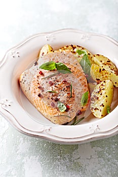 Oven-roasted salmon fillet with baked potatoes