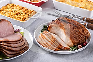 Oven roasted turkey breast thinly sliced with side dishes for a celebration dinner