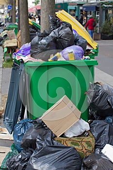 over-consumption, pollution and garbage containers bursting with plastic rubbish